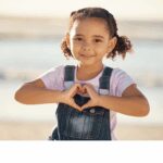 Girl making a heart shape with her hands